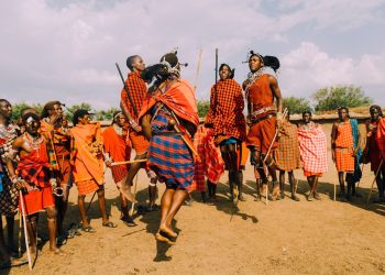 a group of people standing around each other