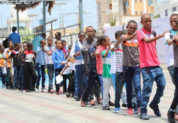 group of people standing on street during daytime